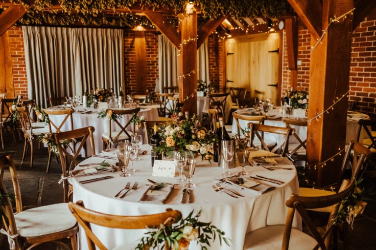 A beautiful wedding breakfast set in in the oak barn of The Ferry House wedding venue in Kent