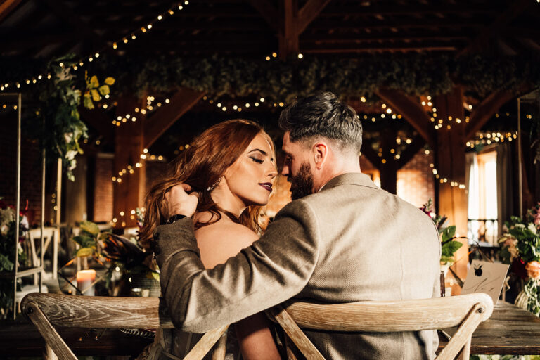 A wedding couple sharing a beautiful moment at a barn wedding venue