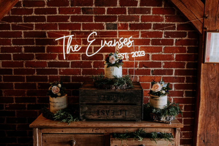 A wedding cake decorated on a vintage dresser