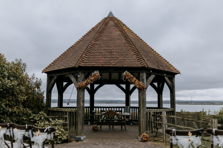 The Oak Gazebo at The Ferry House in Kent dressed with dried summer flowers for an outdoor ceremony.