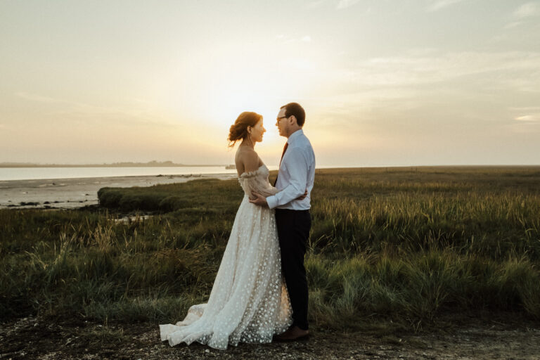 A wedding couple beside the Swale in Kent, at twilight