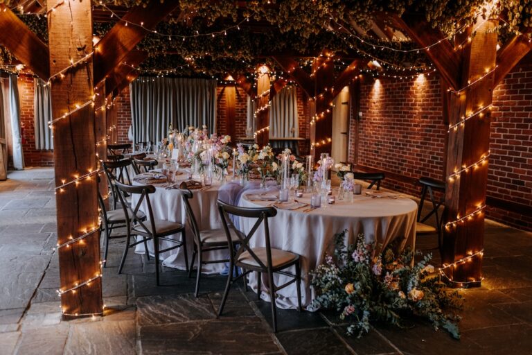 Beautifully styled caterpillar tables at The Ferry House barn wedding venue in Kent